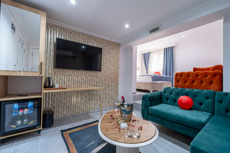 Beachfront hotel surrounded by palm trees and turquoise ocean waves in a tropical travel destination.
